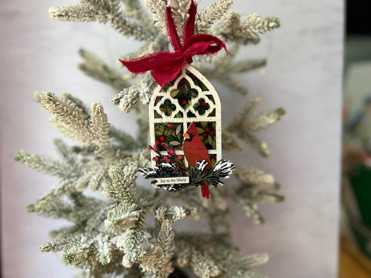 Decorative Christmas ornament with a cardinal on a tree branch